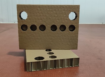 蜂窝纸：源于蜂巢结构原理，瓦楞原纸粘结成正六边形纸芯，两面贴面的新型环保节能材料